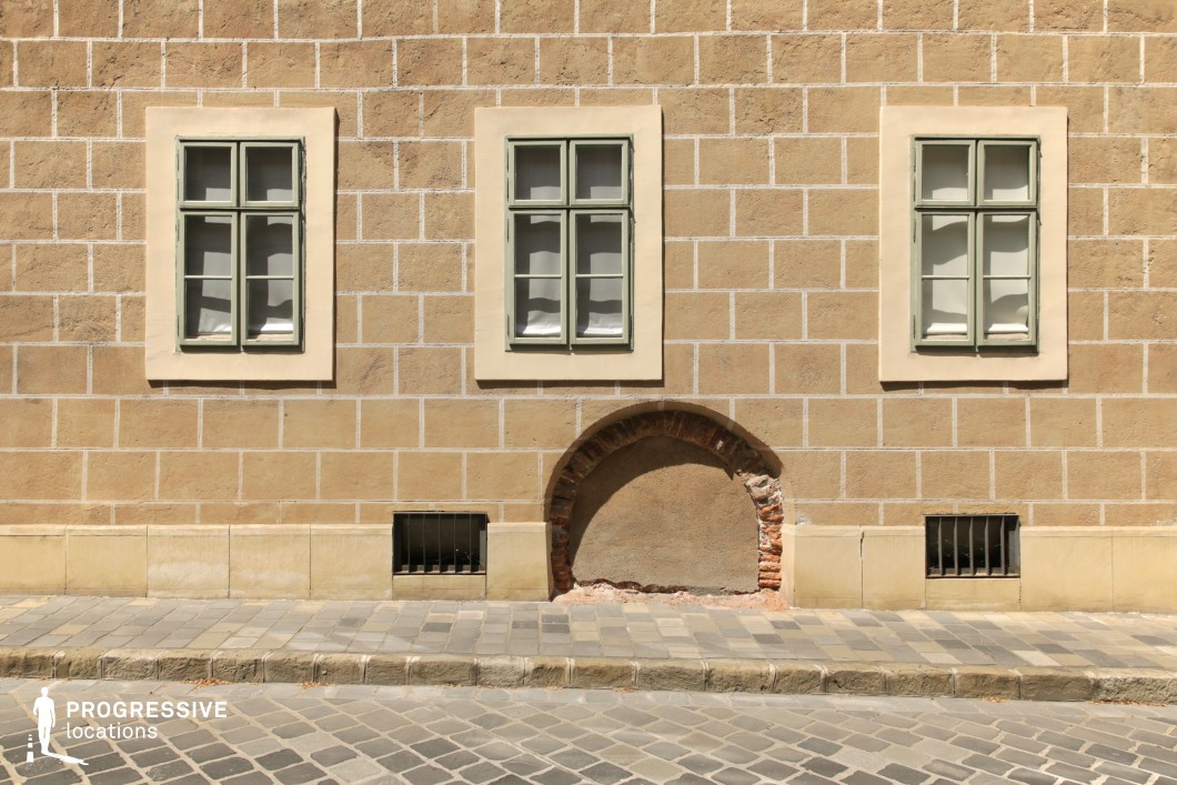 Symmetrical facade with windows and arch detail, film and photography location