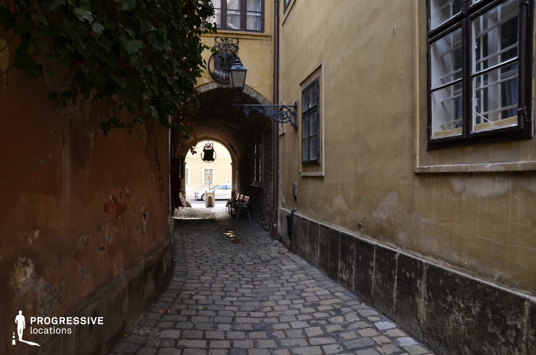 Narrow alley with aged walls and cobblestones, location for photography and filming