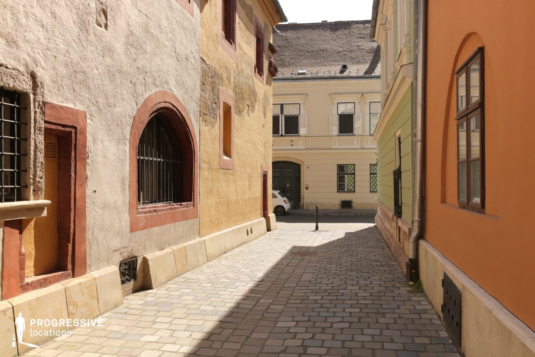 Narrow alley with arched window detail, a film and photography location with textured walls