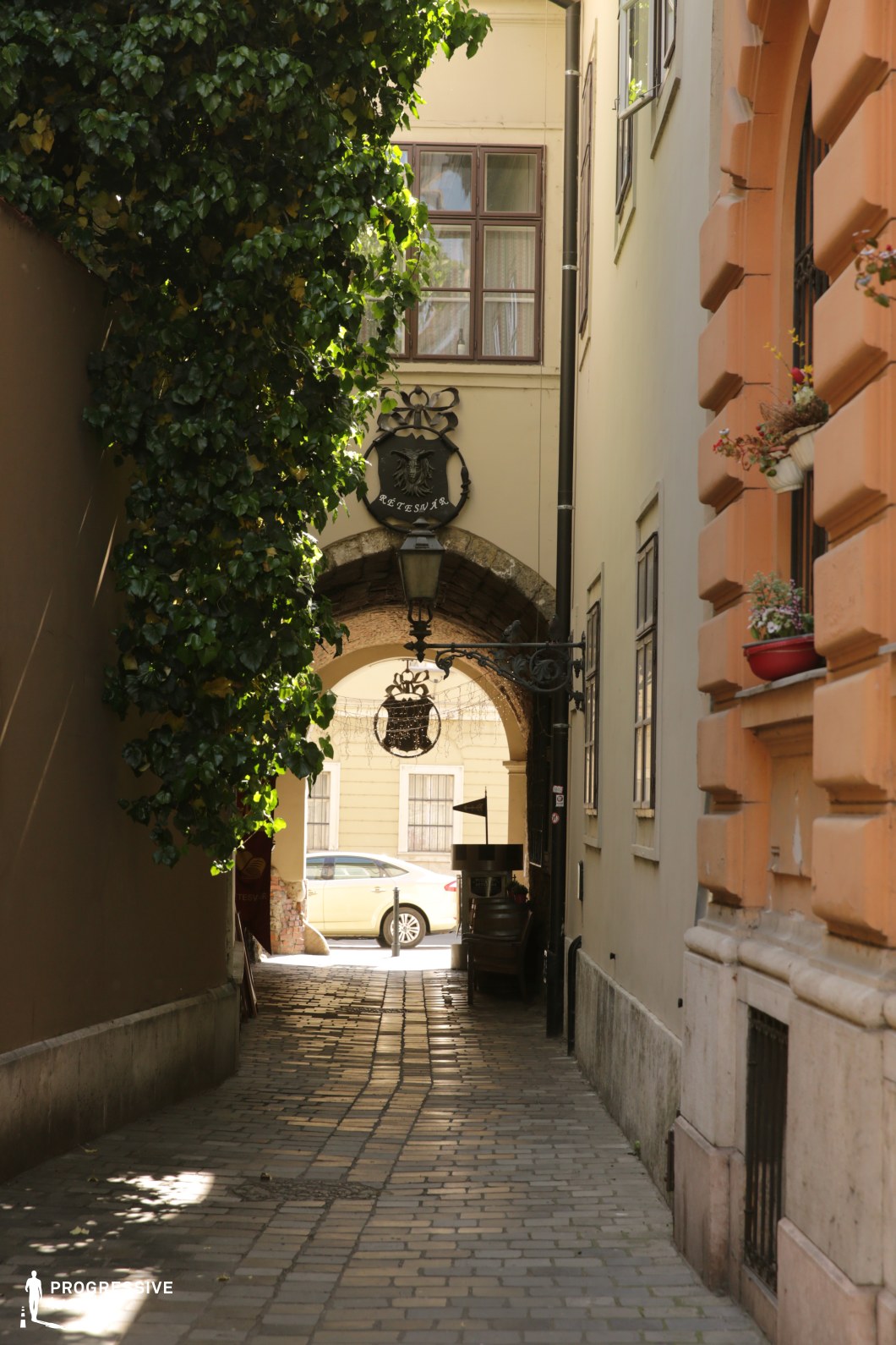 Cobblestone passage with rounded archway, ideal film and photography location