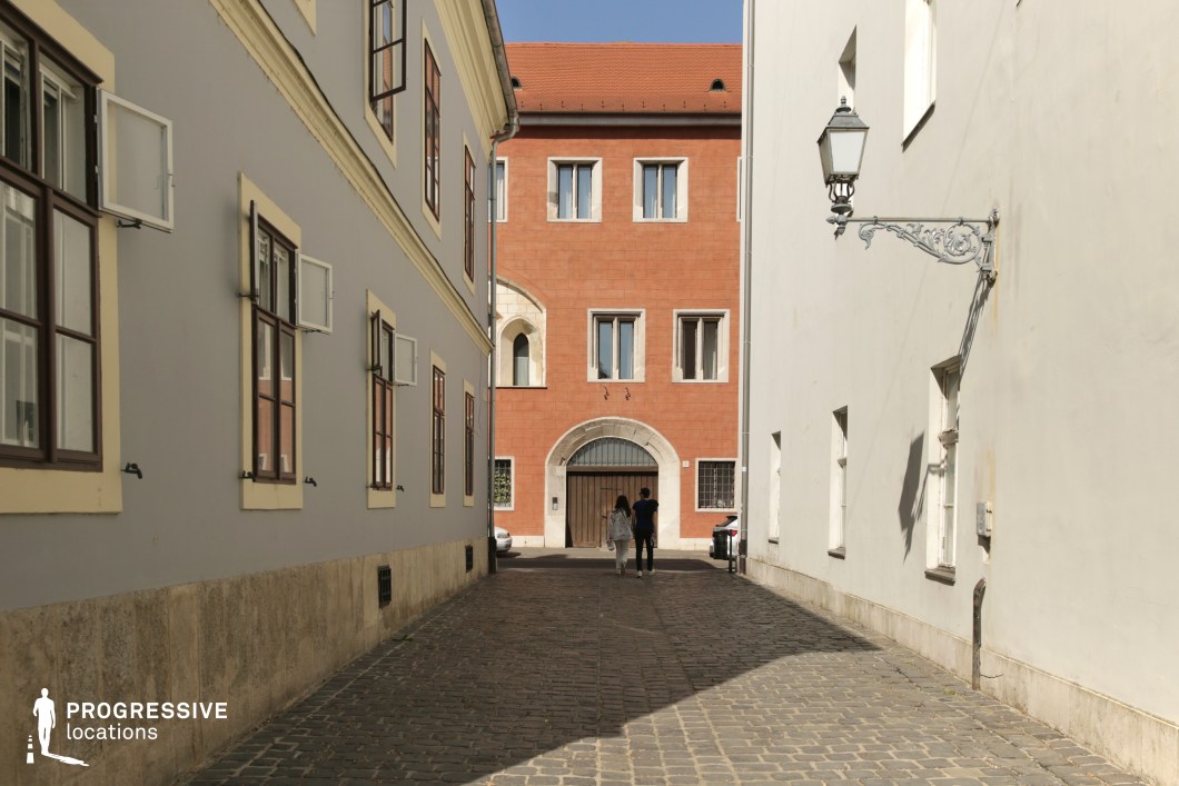 Narrow passage with arched doorway, a clean film and photography location setting