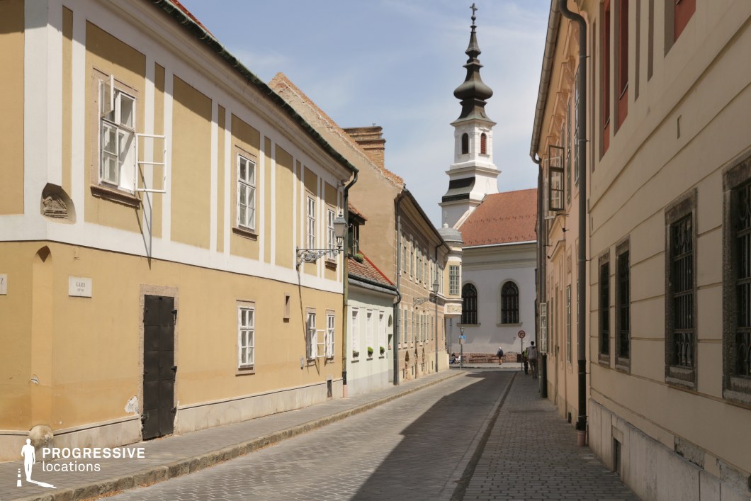 Narrow street aligned to baroque tower, a photography and film location with strong perspective