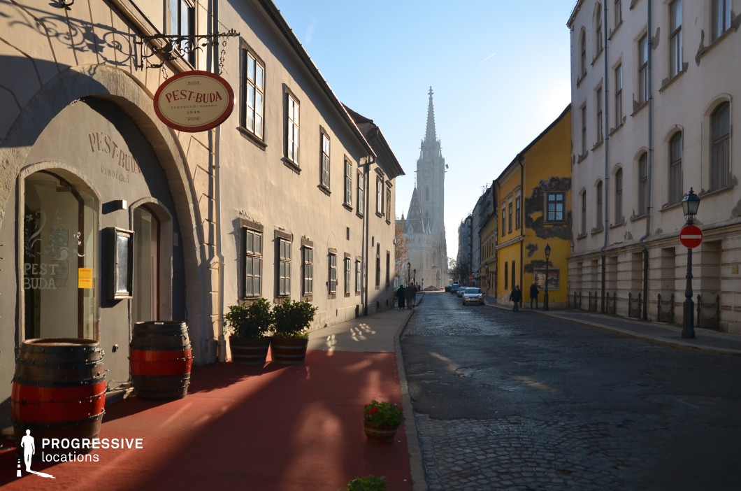 Narrow street leading to church tower, a strong photography and film location composition