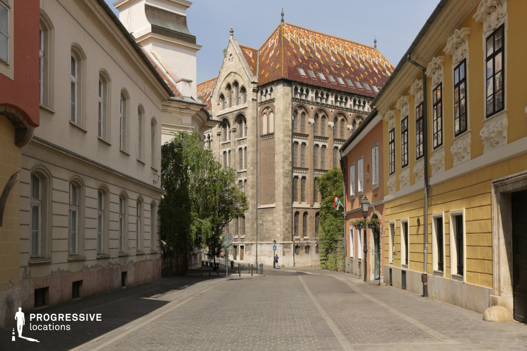 Narrow street aligned to patterned roof building, a film and photography location with strong perspective