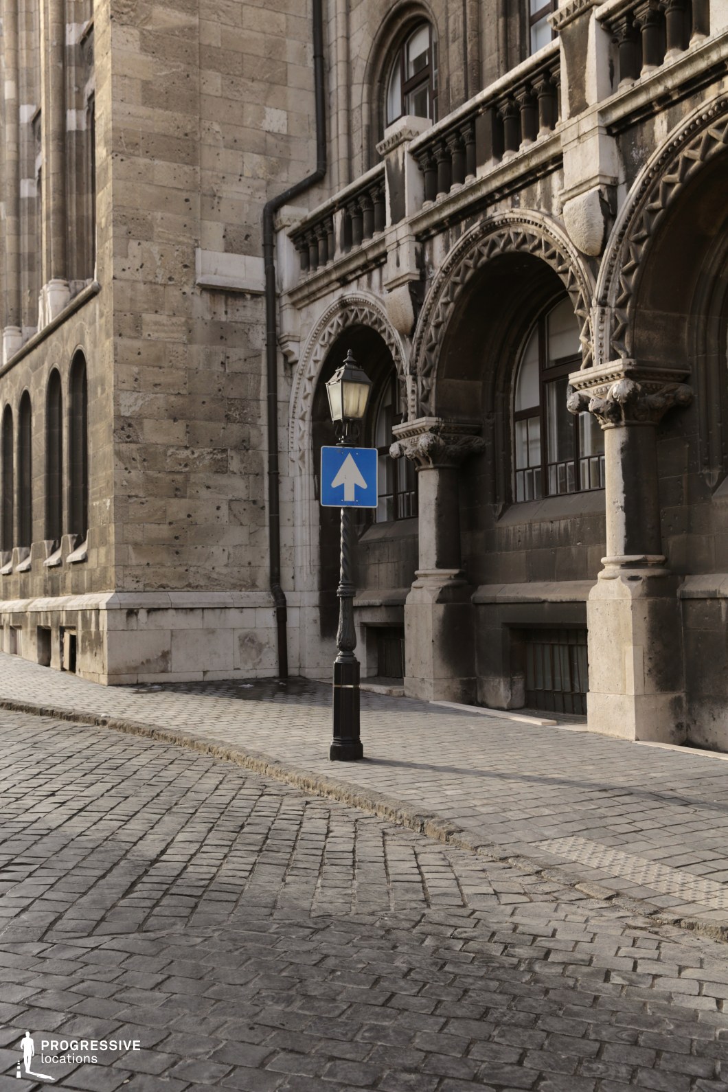 Stone facade with arched openings and columns, ideal location for photography and filming