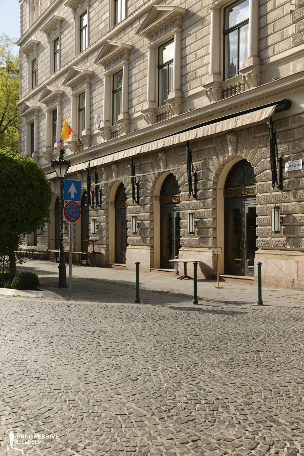 Historic boulevard with neoclassical stone facades functions as a photography and film location with refined urban character.