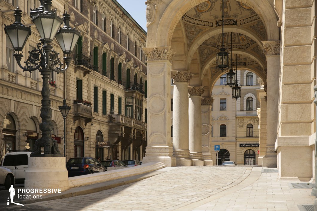Historic arcade corridor and cobblestone approach form an ideal film and photography location with strong perspective lines.