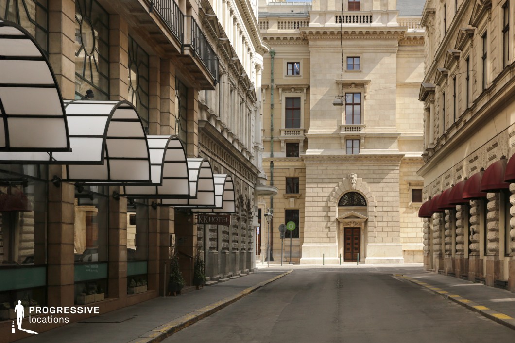 Symmetrical historic street with arcades functions as a photography and film location with strong architectural perspective.