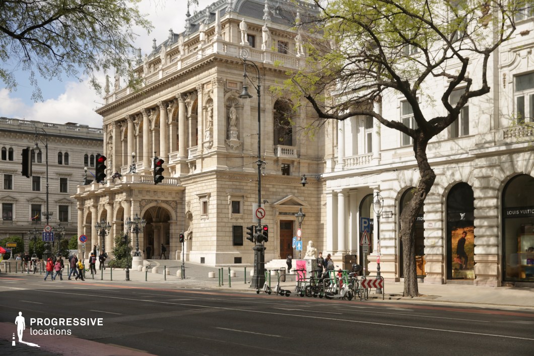 Grand opera building on a wide boulevard presented as an ideal location for photography and filming in a historic district.