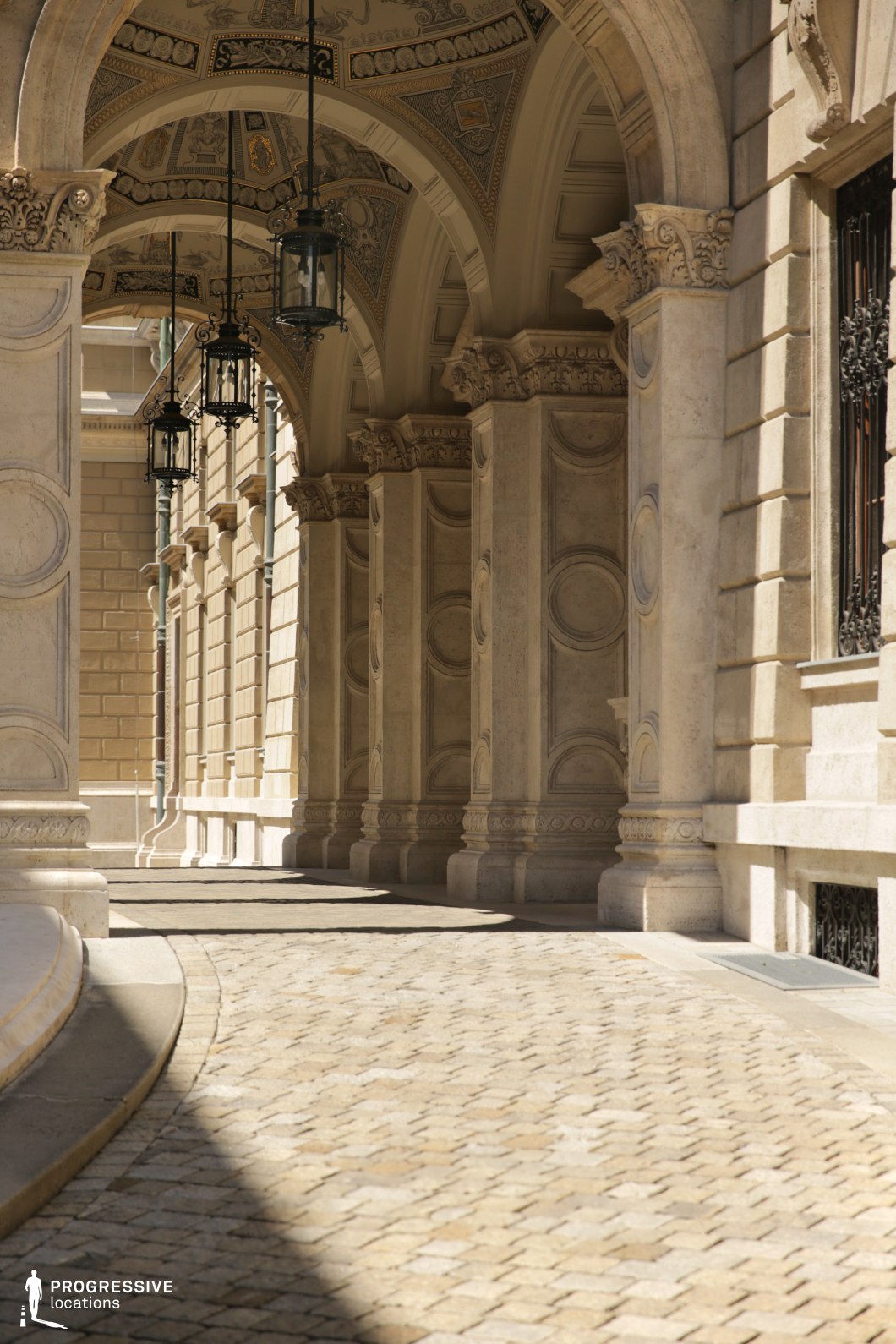 Ornate vaulted arcade with carved stone arches serves as a film and photography location with historic character.
