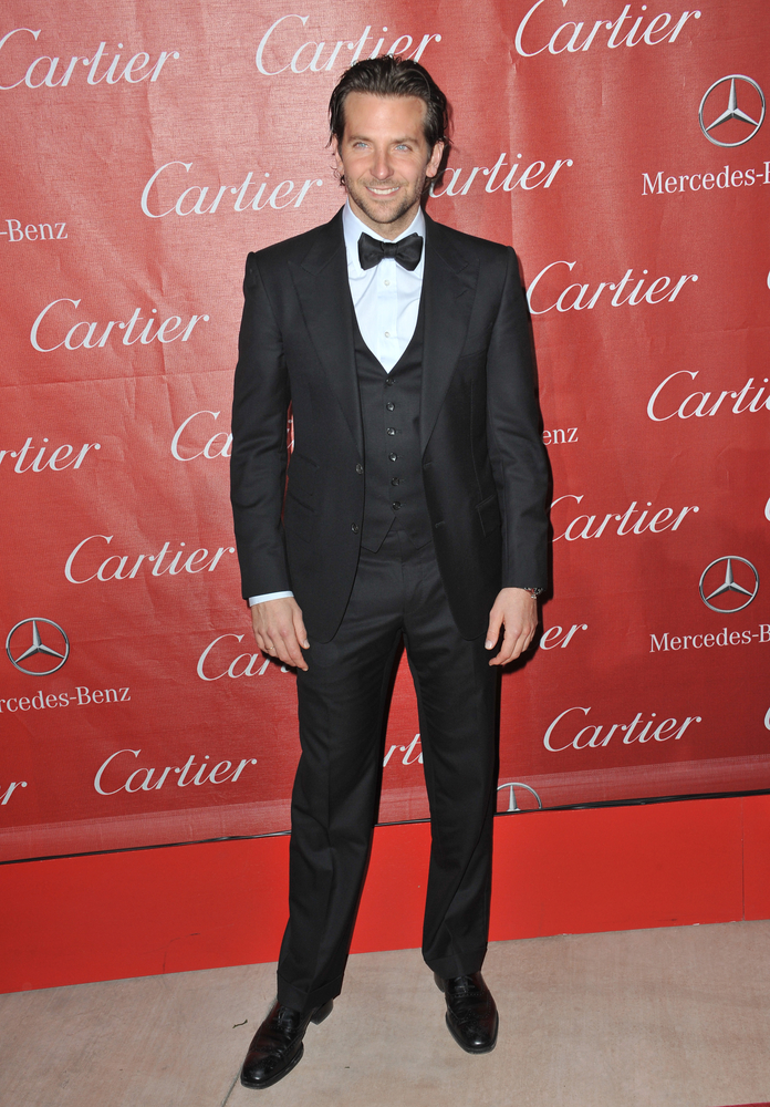 Bradley Cooper cuts a dashing figure in navy suit as he models a