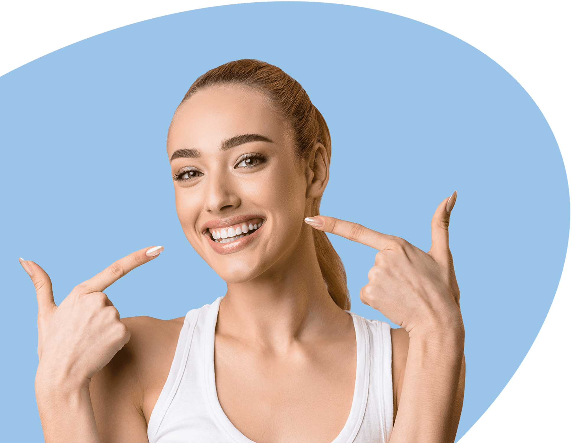Woman pointing to teeth and smiling.