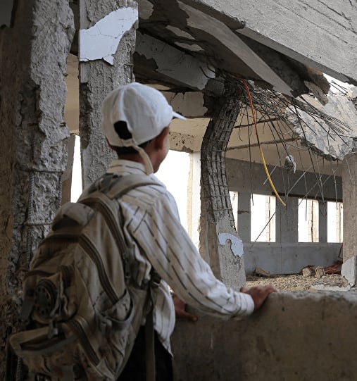 School student looking at his damaged school