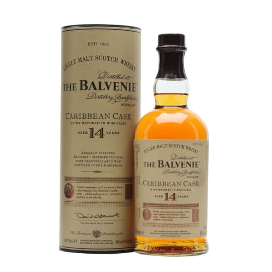 Balvenie Caribbean Cask 14 Year - 750mL - The Balvenie Caribbean Cask 14 is a highly popular Speyside single malt Scotch whisky. After maturing for 14 years in traditional oak casks, it is finished in American oak casks that previously held Caribbean rum. This unique process imparts a smooth, honeyed character combined with rich notes of toffee, vanilla, and tropical fruit.