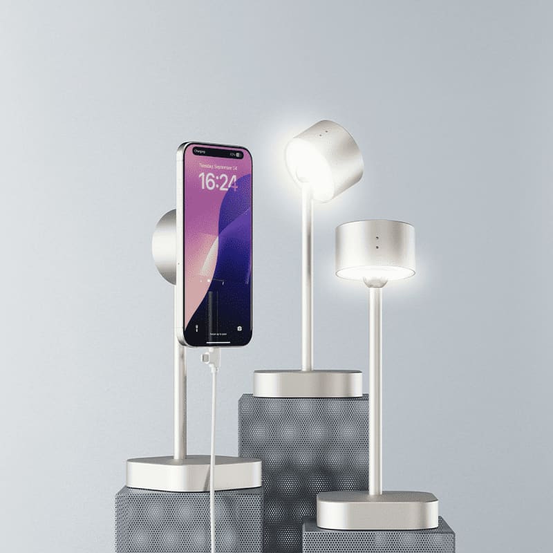 A smart lamp in silver with a minimalist design, featuring a phone charging on a pedestal.
