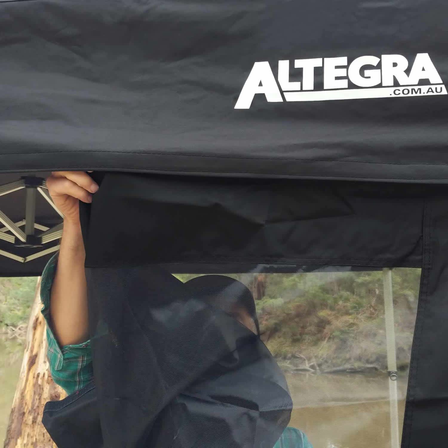 A black gazebo wall with a clear section, featuring an attached logo at the top.