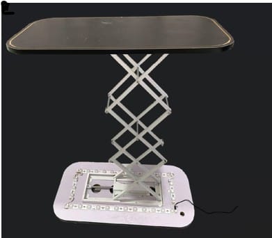A hydraulic counter with a black rectangular top and a silver scissor lift base, featuring a light-up platform.