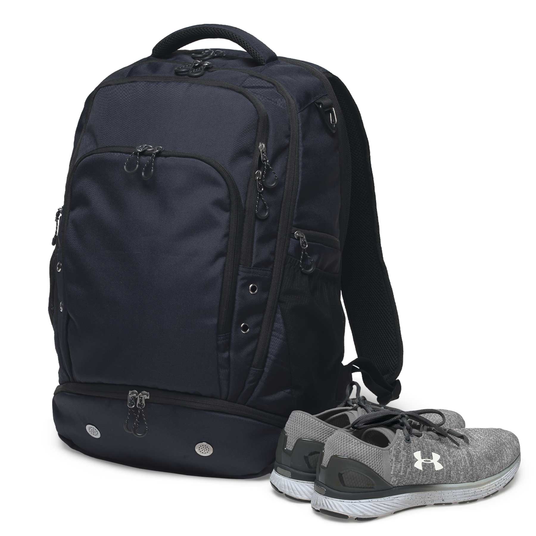 A navy backpack with multiple pockets, accompanied by a pair of grey sports shoes. The bag has a logo.
