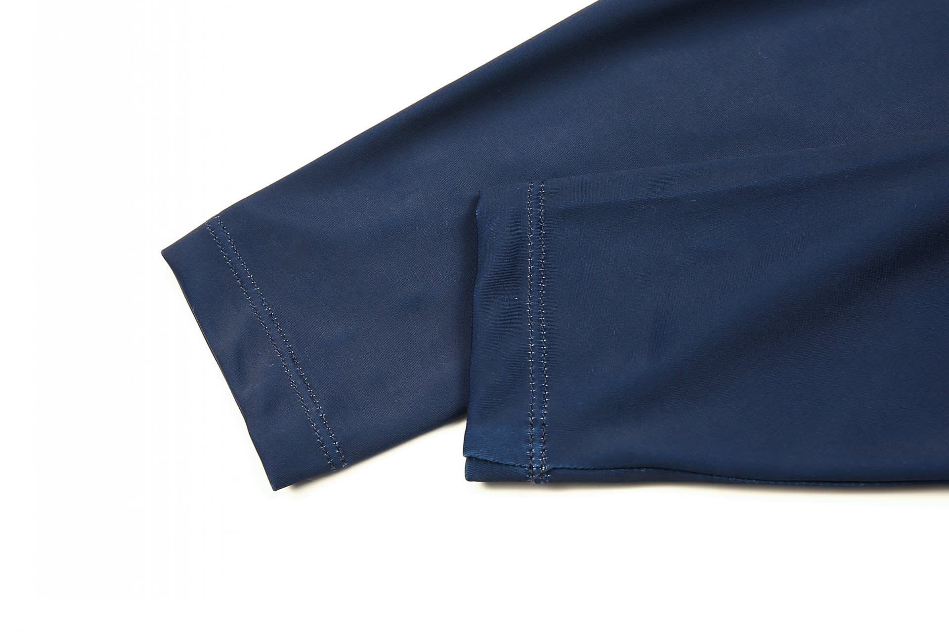 A close-up of a navy INLINE SPEED SKATING SUIT, featuring smooth fabric and stitched edges.