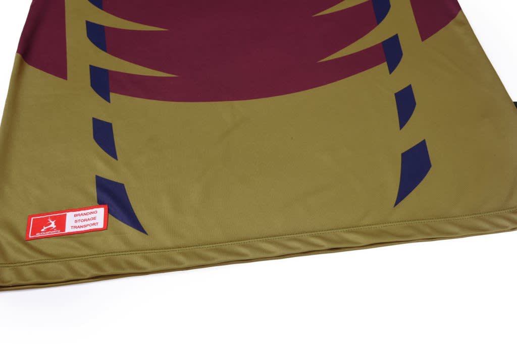 A promotional product featuring a large, patterned fabric in green, maroon, and navy blue, with branding visible.