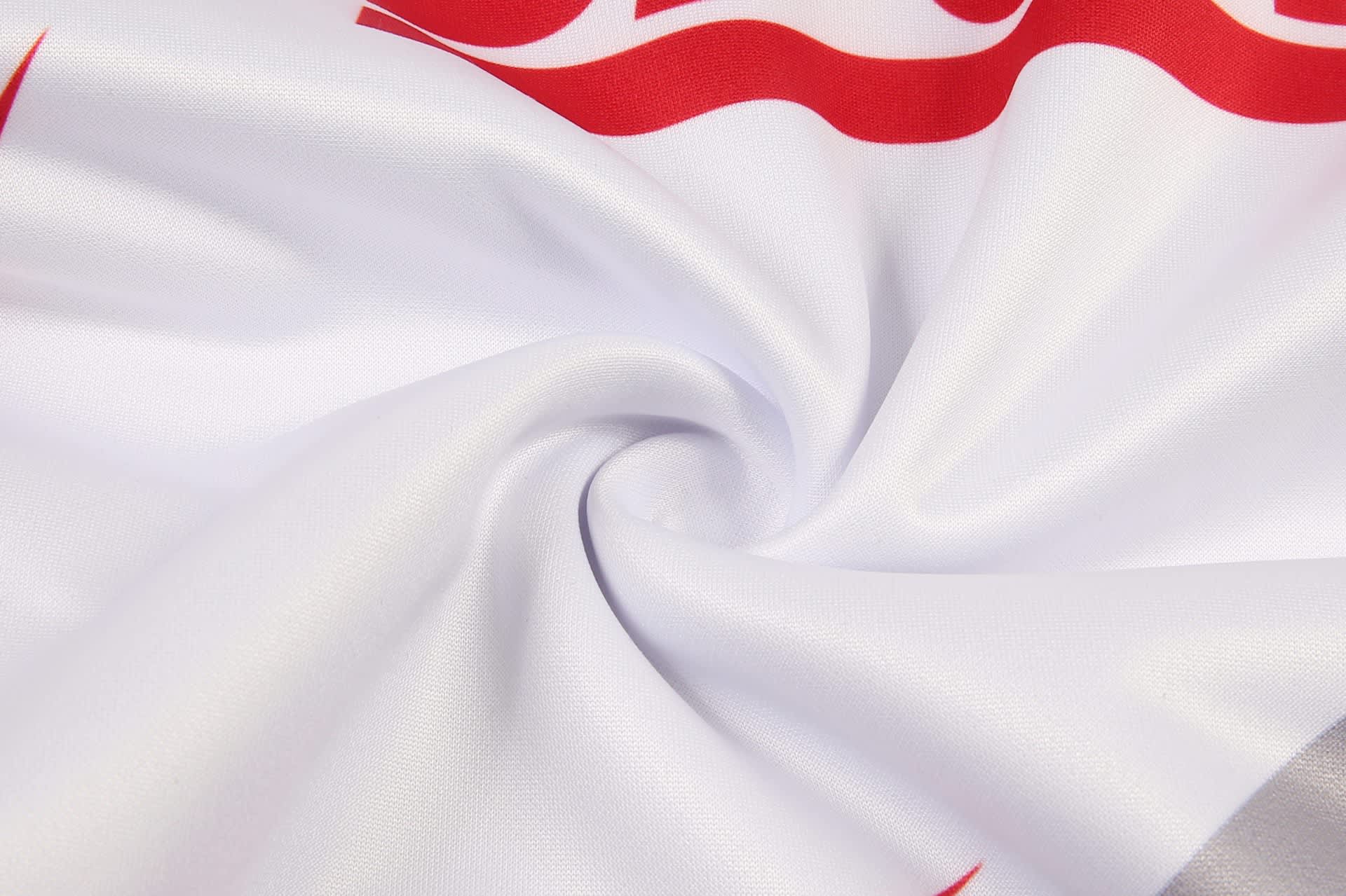 A white fabric featuring a smooth texture with red design elements and a logo.