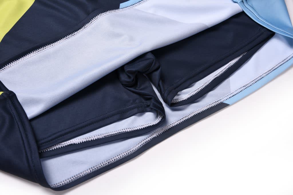 A skort featuring a combination of navy, light blue, and green fabric, with an inner short section visible.