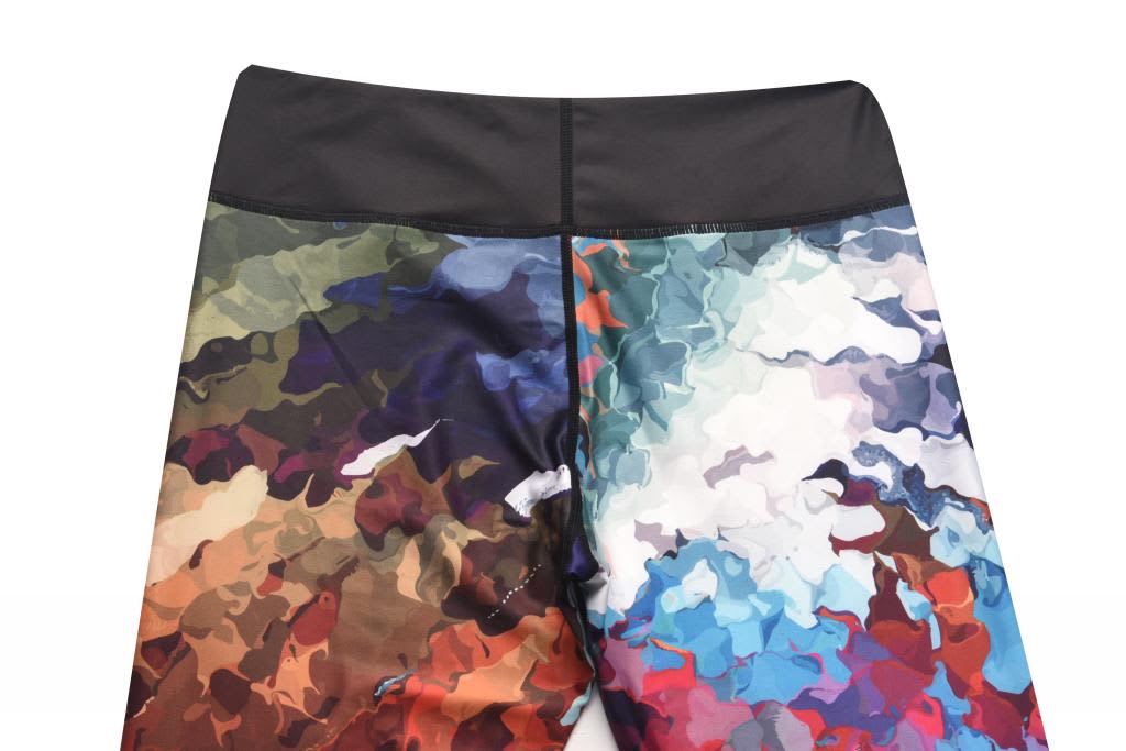 Tight leggings for ladies featuring a multicoloured abstract pattern with a black waistband and logo.