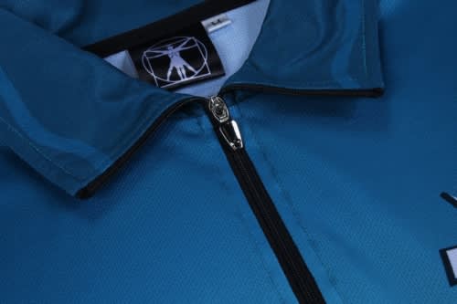 A blue sports jersey with a zippered collar and a logo on the chest area.