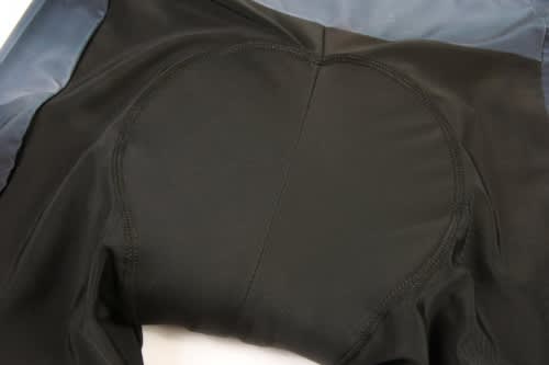 A black cycling uniform featuring a padded seat area and a smooth surface. The item includes a logo.