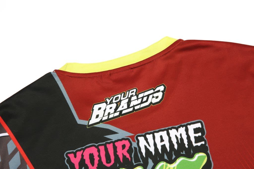 A red BMX club jersey with yellow collar and a logo, featuring colourful design elements and placeholders for customisation.