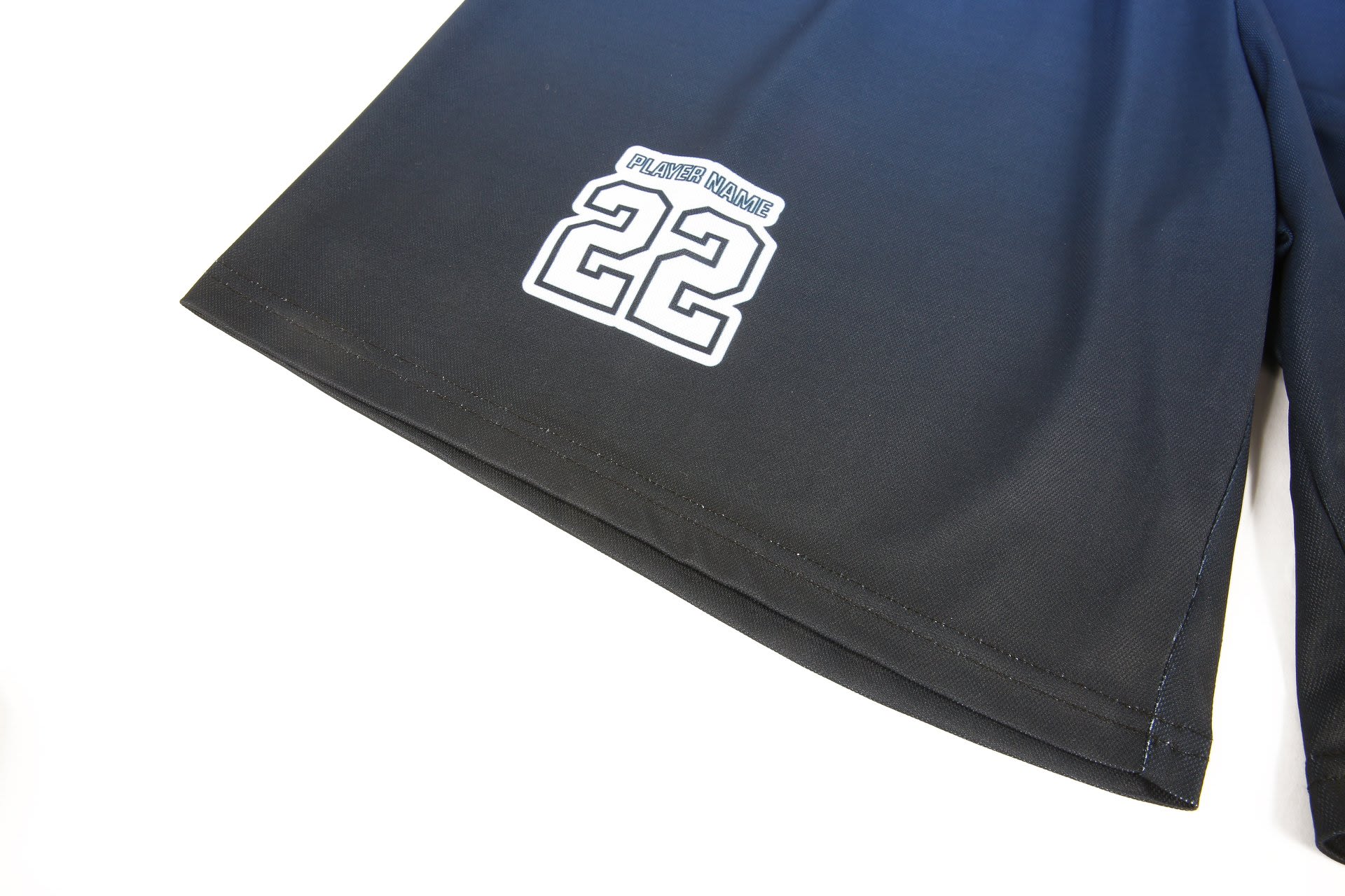 A pair of black sports shorts with a gradient design, featuring a logo and the number 22.