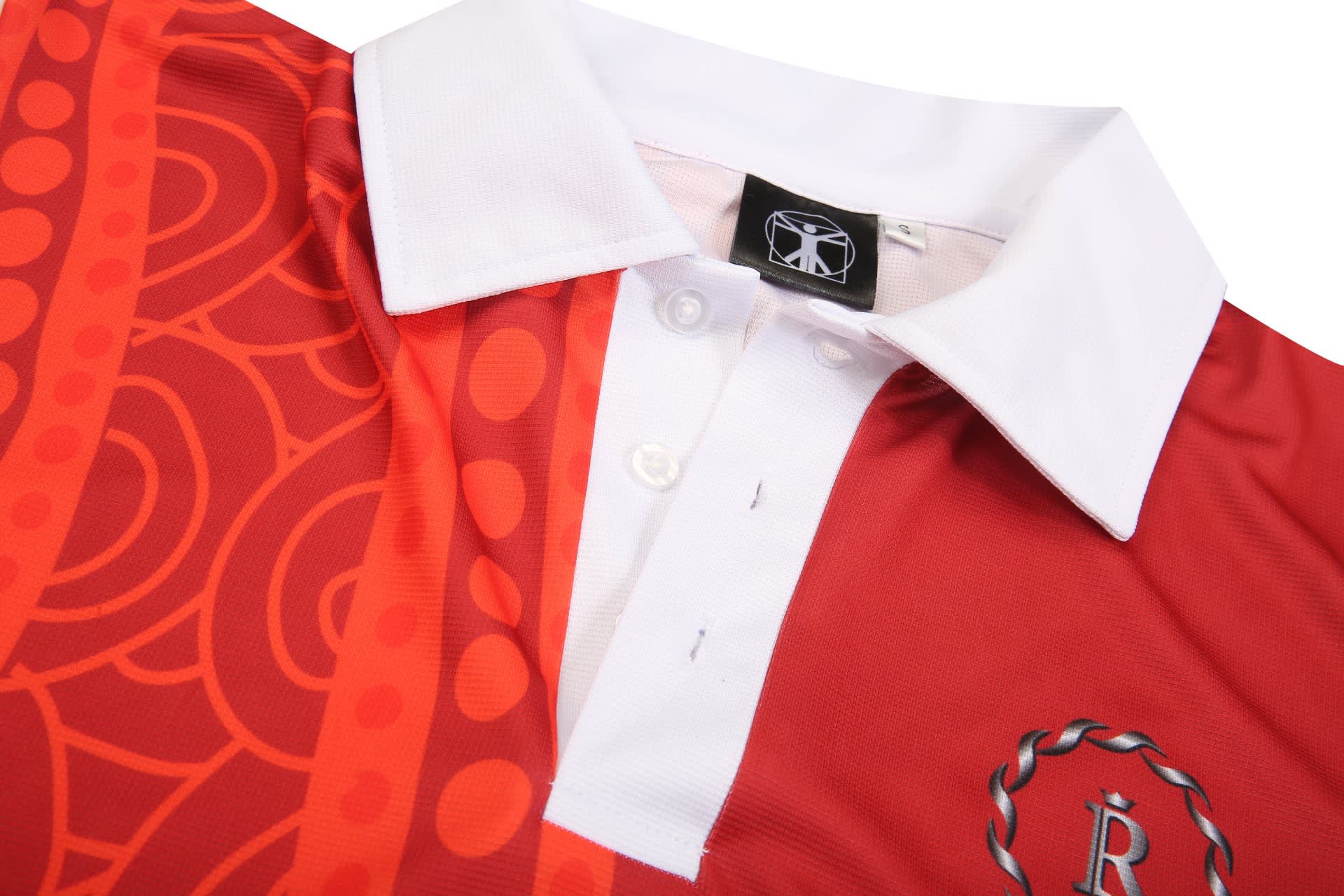 A red and orange hotel uniform shirt with a white collar and a logo on the front.