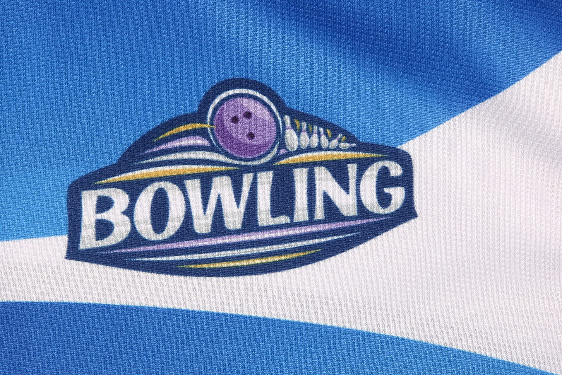 A blue and white sports jersey with a logo featuring a bowling ball and pins.