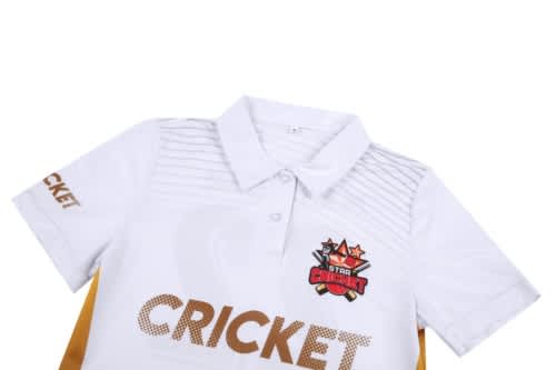 A white cricket uniform featuring a collar, decorative stripes, and a logo. The word "CRICKET" is prominently displayed.