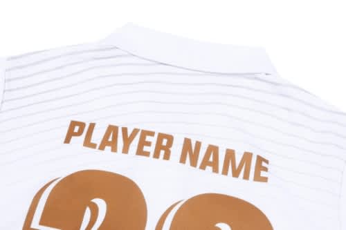 A white cricket jersey featuring a collar and striped pattern, with a large number and placeholder for a player name.