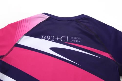 A sports dress featuring a combination of navy blue, pink, and white colours, with a logo on the back.