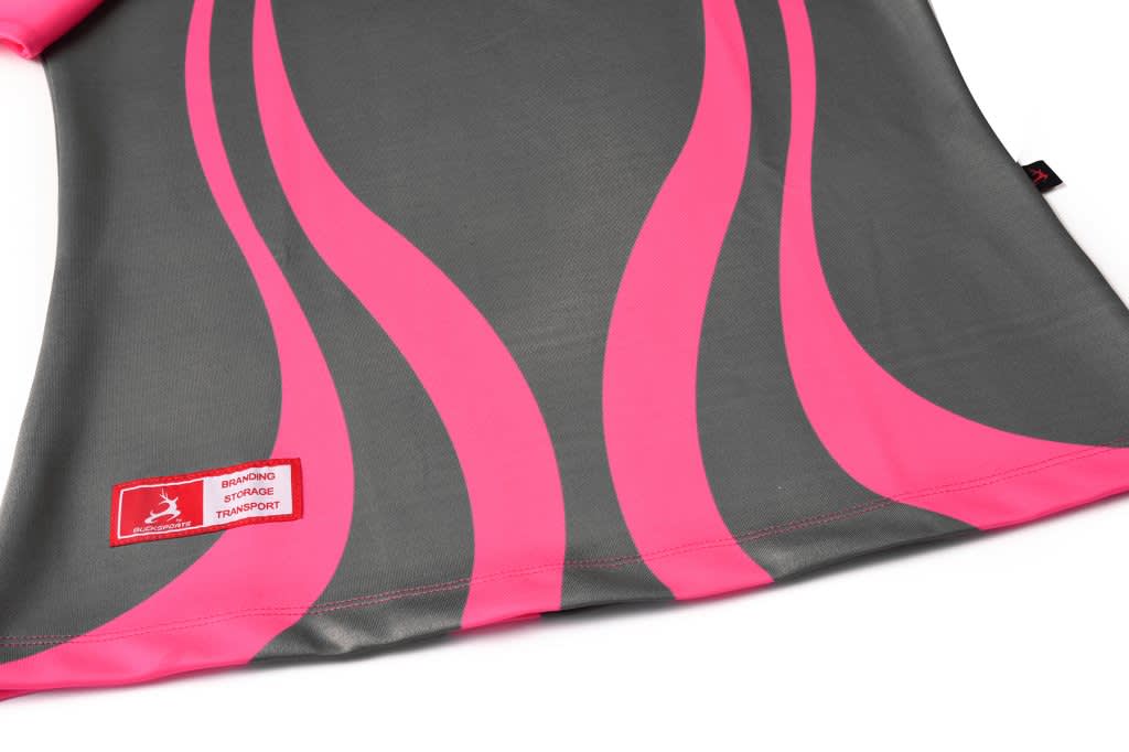 A grey polo shirt featuring bold pink wavy stripes, with a logo on the lower hem.