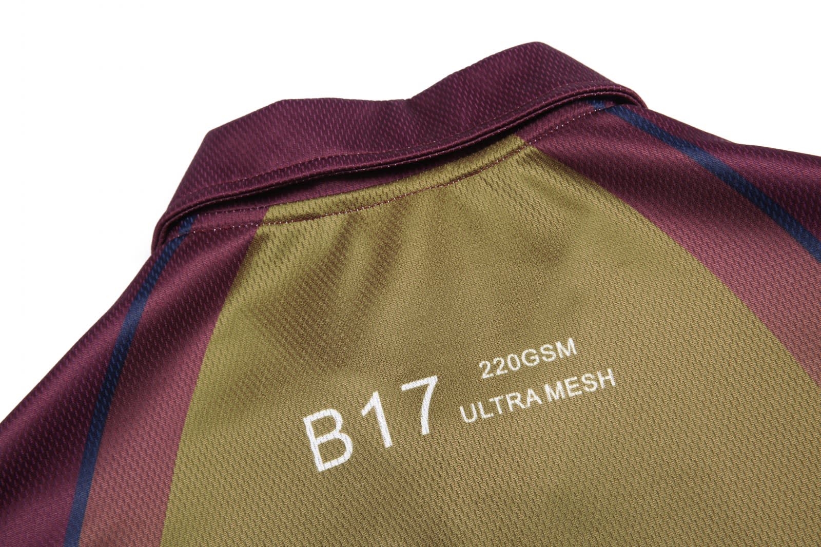 A collared polo shirt in burgundy and olive green, featuring a mesh design and a logo on the back.