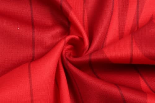 A vibrant red fabric with horizontal stripes, suitable for a sports uniform, featuring a smooth texture.