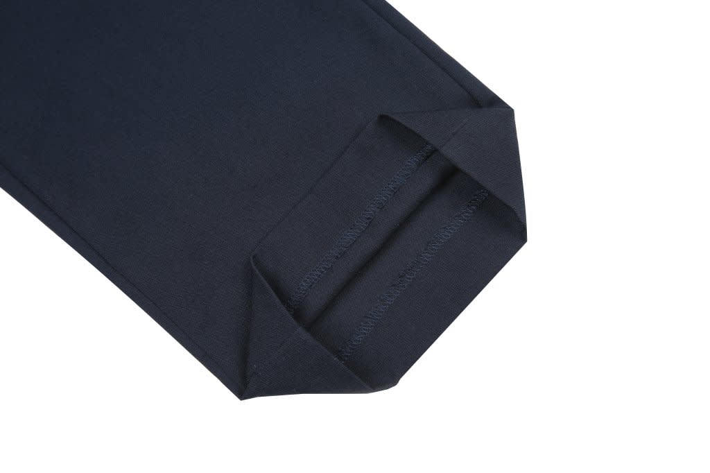 A navy lawn bowling uniform featuring a neatly folded sleeve with a branding logo.