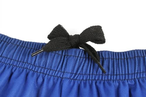 A close-up of a blue sports uniform featuring a black drawstring bow detail at the waistband.