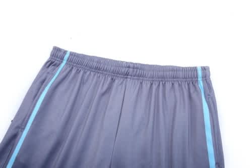 Grey training zip pants with a blue stripe, featuring an elastic waistband and a logo.