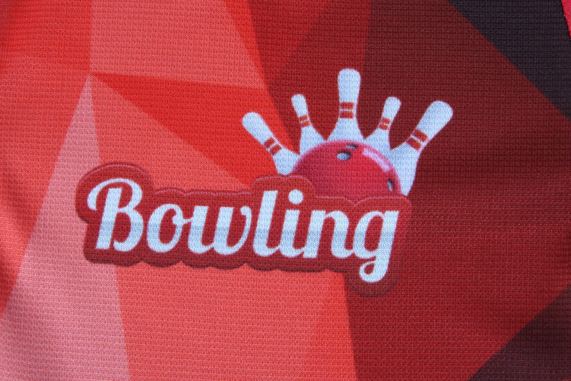 A red and black bowling team uniform featuring a bowling ball and pins graphic, with a logo on the front.