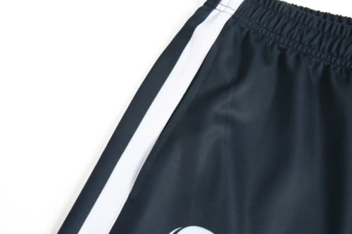 A sports uniform featuring dark navy fabric with white side stripes and a logo.