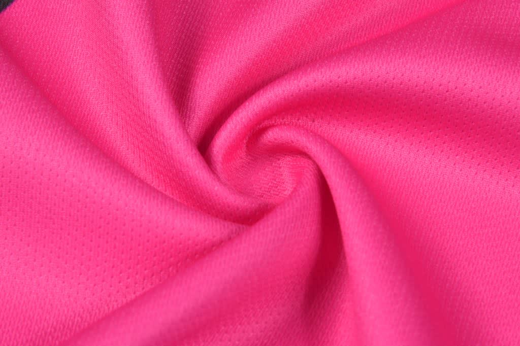 A vibrant pink fabric with a textured surface, showcasing a smooth, swirling pattern. The material appears lightweight and breathable.