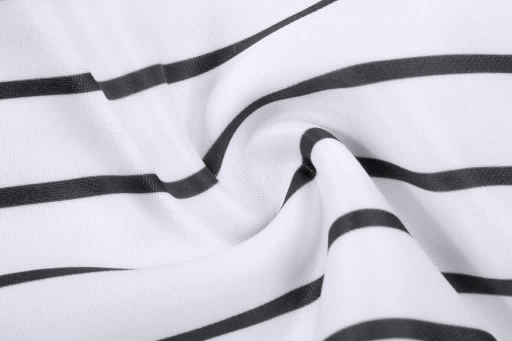 A close-up of white fabric with black horizontal stripes, featuring a smooth, twisted texture.