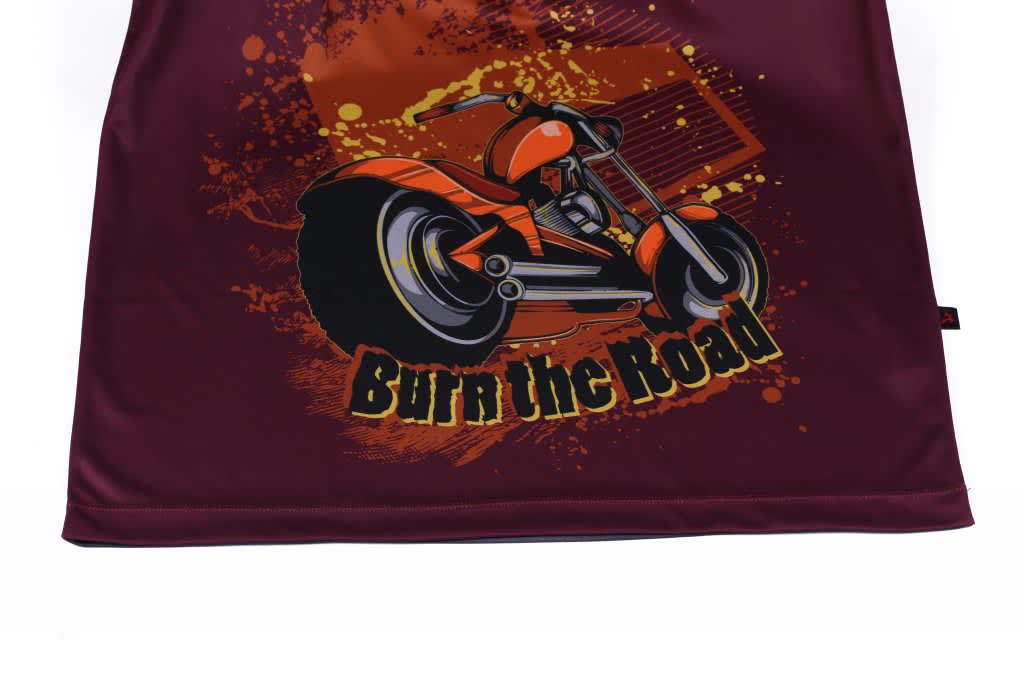 A maroon promotional shirt featuring an orange motorcycle graphic with a splash design and a logo.