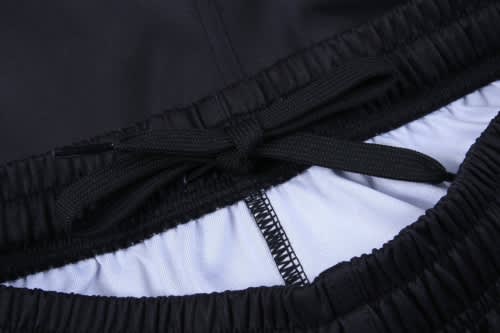 Black athletic shorts with an elastic waistband and a drawstring, featuring a lighter inner lining.