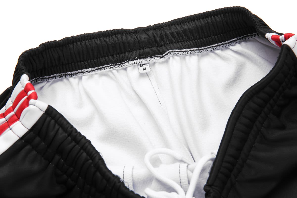 Black training pants with a white inner lining and red accents, featuring an elastic waistband and drawstring.