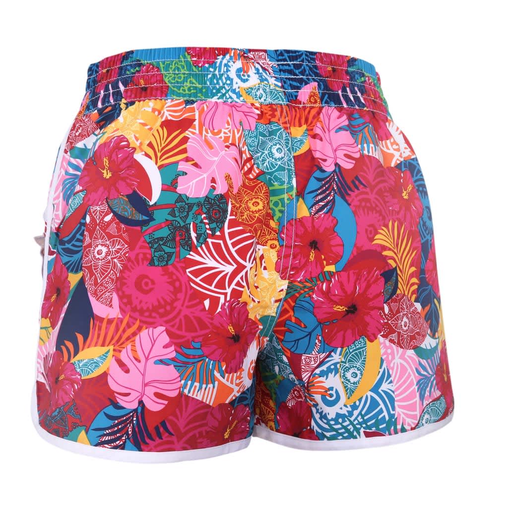 A pair of vibrant women’s boardshorts featuring a colourful floral pattern in shades of pink, red, blue, and green.